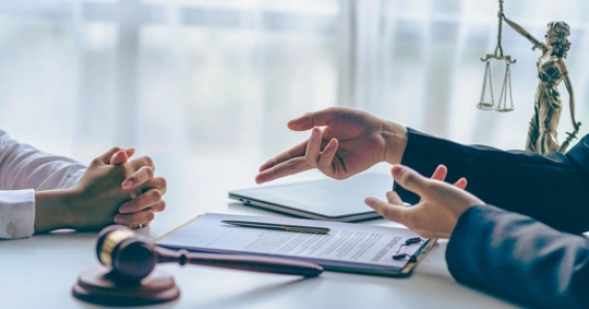Lawyer working with client discussing plea agreement documents