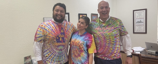 2 men and a woman in tye dye shirts