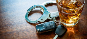 car keys, whiskey and handcuffs on a table in El Paso