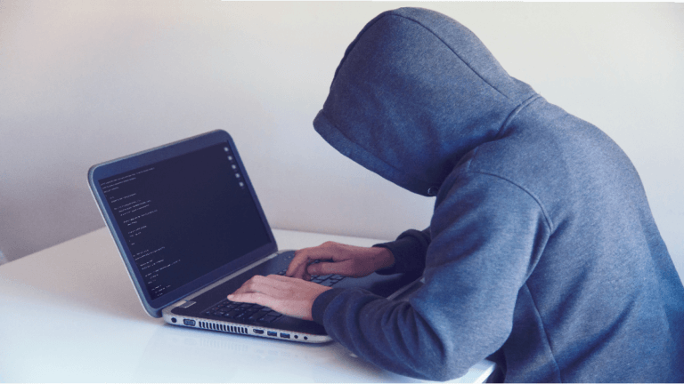 Man on computer attempting to steal an identity.