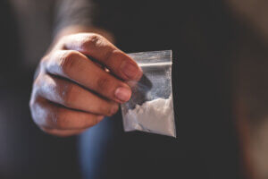 Man holding bag full of cocaine